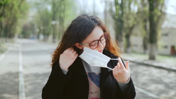 Young Girl Takes Off a Medical Mask alt