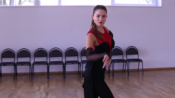 Professional and passionate female dancer dances on the dance floor alt