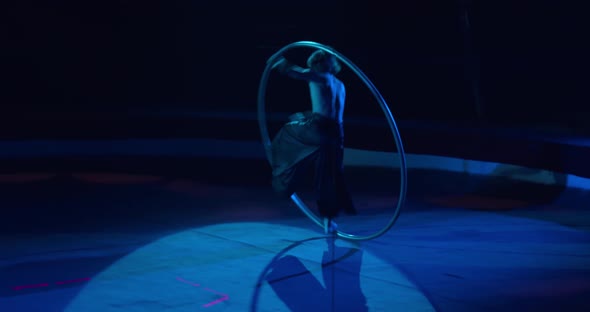 Wheel Gymnastics Tricks Performed By a Young Man on Stage of a Circus alt