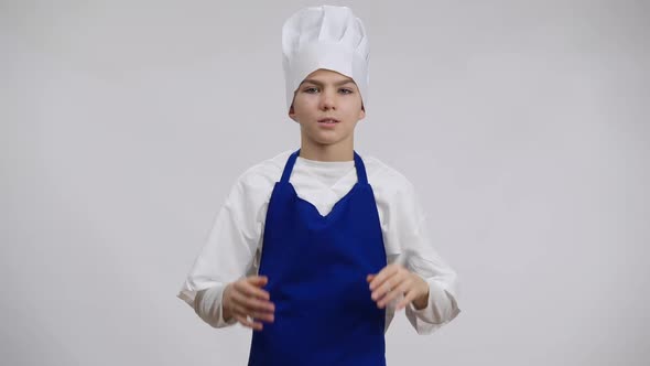 Stressed Little Cook Rubbing Temples Pulling Chef Hat on Head alt
