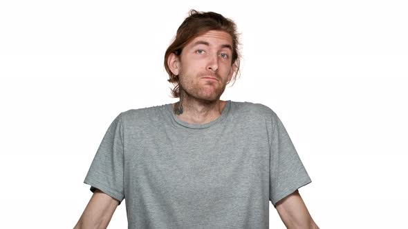 Portrait of Puzzled Tall Guy in Casual Shrugging with Helpless Gestures and Throwing Up Hands in alt