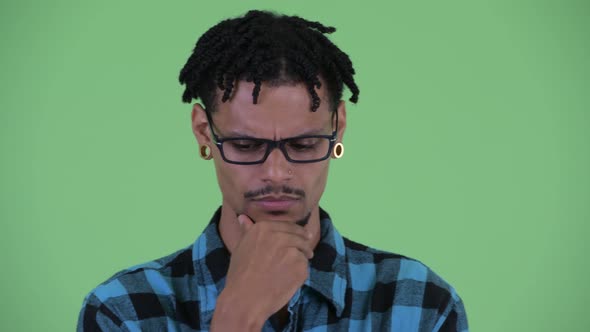 Face of Stressed Young African Hipster Man Thinking and Looking Down alt