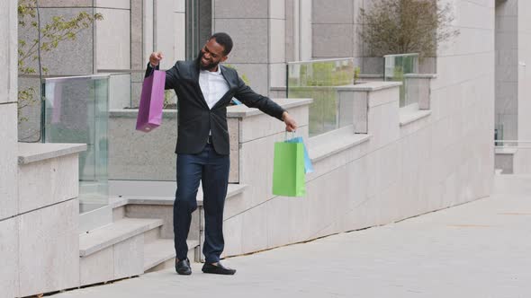 Millennial Young Adult Black Male Student Personal Assistant Walking Out of Mall Boutique Store with alt