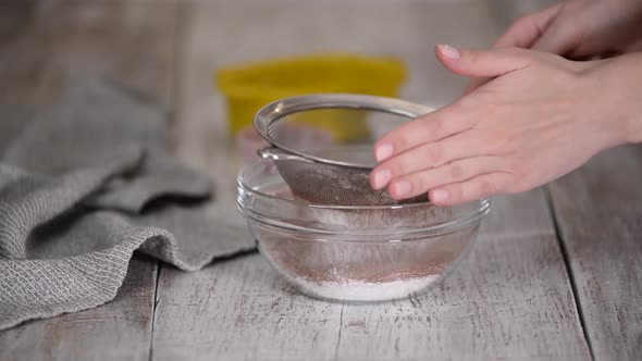 Woman Hands Sieving Flour and Cocoa Powder