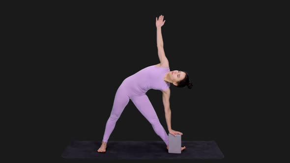 Young Sporty Woman Doing Triangle Pose while Practicing Yoga, Alpha in