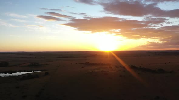 Panning cinematic aerial shot of an African sunset alt