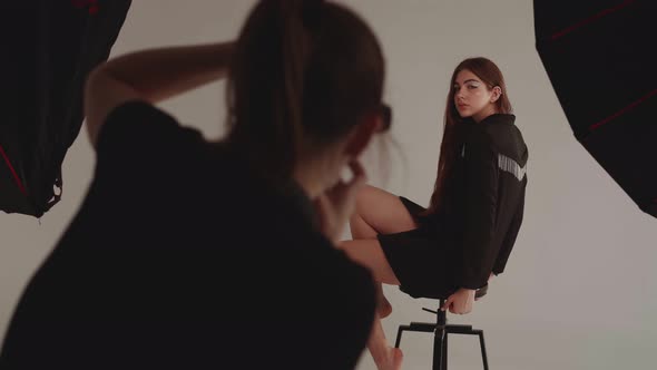 Woman Photographer Photographing Model in Studio
