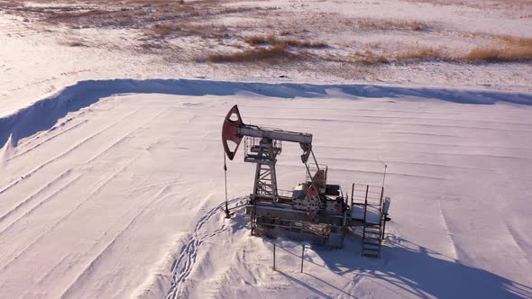 Pump Jack in Vast Oil Fields in Winter