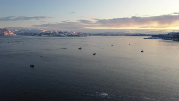 Sea and snow covered coast at sunset, Tromso, Norway