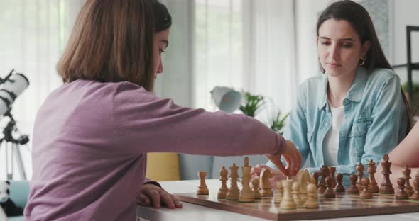 Children playing chess at home