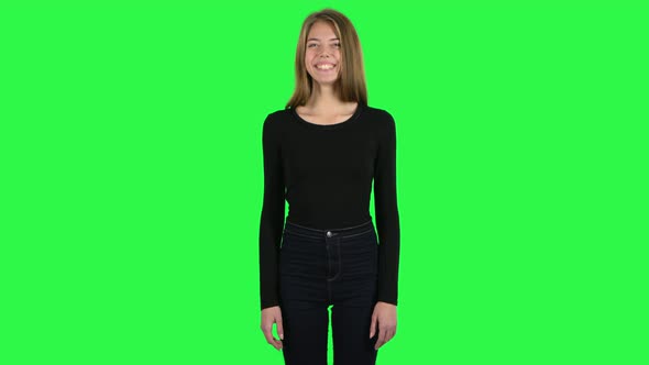 Young Woman Smiling While Looking at Camera and Laughing. Green Screen alt