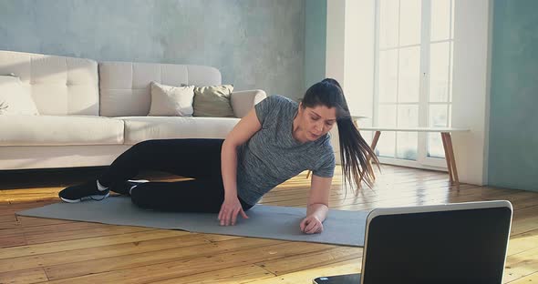Woman Does Supine Side Leg Raises at Online Training alt