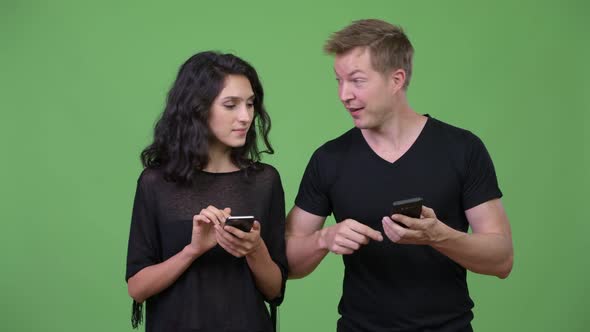 Young Couple Using Phone Together alt