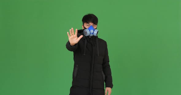 Man Wearing Pollution Mask On A Green Screen alt