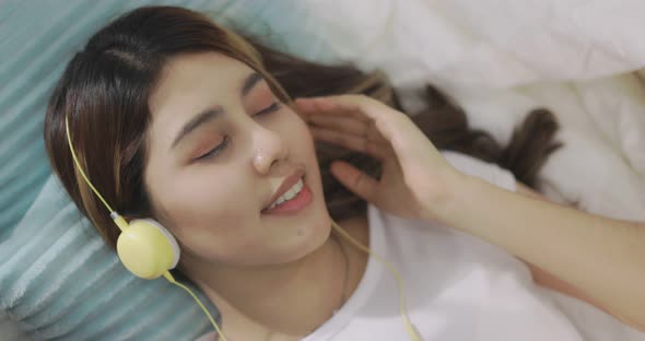 Close Up Happy Asian Woman Listening To Music By Headphones. alt