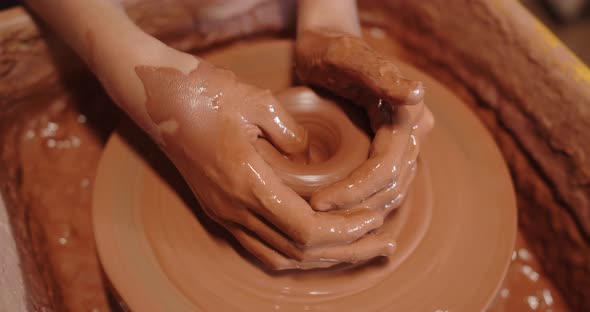Pottery. Hands Form Ceramic Products From Clay By Means Of A Potter's Wheel