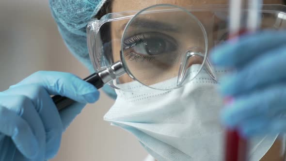 Female Lab Worker Examining Sample to Restore Density and Presence of Sediments alt