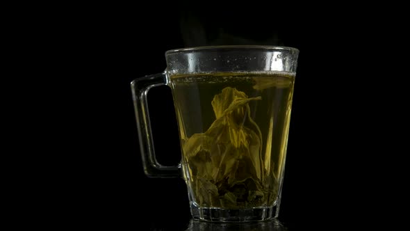Tea leaves in a transparent cup.  alt