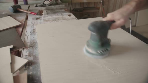 Carpenter Uses a Grinding Machine to Align