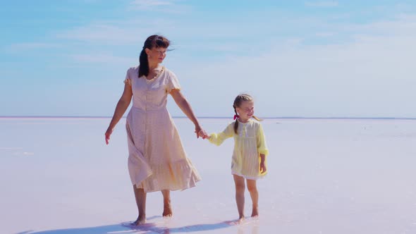 Mother and Daughter Walk Along Salt Lake alt