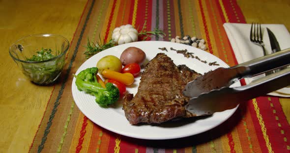 A Porterhouse Or T-bone Steak Served With Vegetables 46b