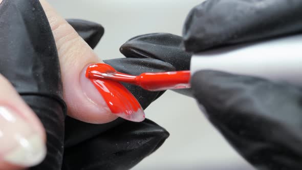 Applying a Layer of Red Varnish to the Nail Surface alt