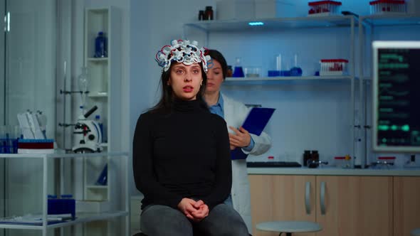 Doctor Researcher Adjusting EEG Headset Analyzing Patient's Evolution alt