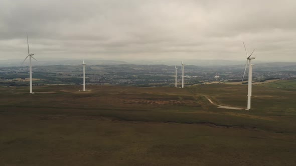 A group of wind turbines on a hill alt