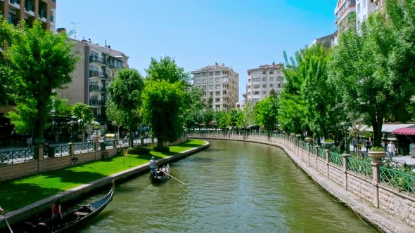 People Rowing Boats on the River alt