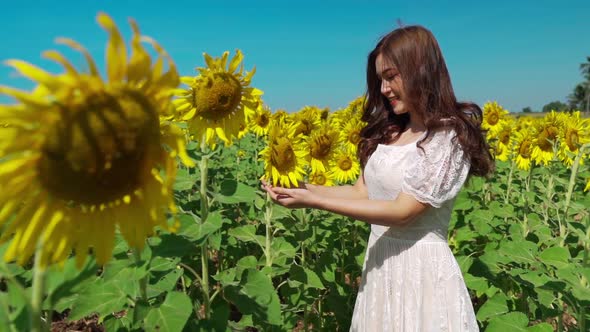 slow-motion of cheerful woman enjoying with sunflower field