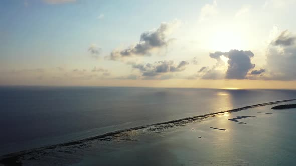 Aerial drone shot panorama of marine tourist beach vacation by clear sea and white sandy background  alt