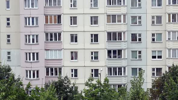 Windows Of A Multi Storey Panel Building. At The Bottom Of The Frame, The Tops Of The Trees alt