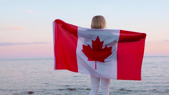 Back View Woman in Summer Clothes with National Canada Flag Outdoors Ocean Sea Sunset Canada Flag alt