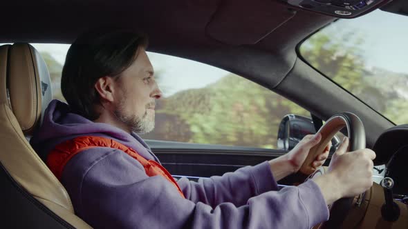 The driver driving the car talks to the passenger.