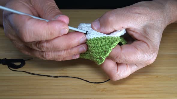 Seamstress is Sewing Shoes with a Crochet