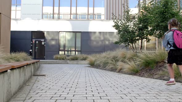 An Elementary School Student Hurries to School alt