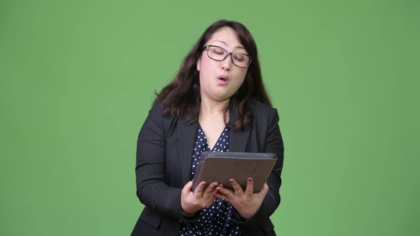 Mature Beautiful Asian Businesswoman Using Digital Tablet alt