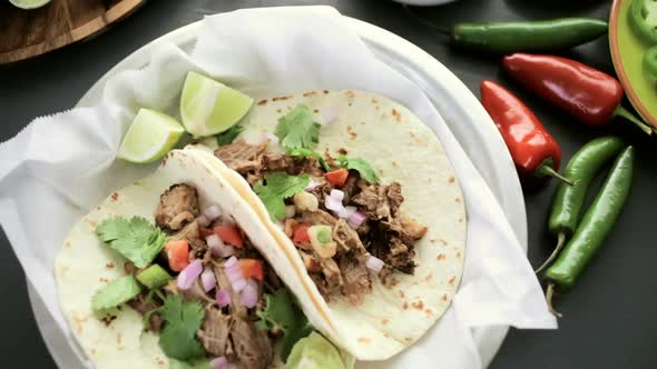 Pulled pork carnitas with pico de gallo on a flour tortilla. alt