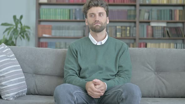 Cheerful Young Man Leaving the Sofa alt