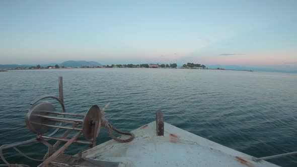 Point of view from inside of a sailing fishing boat. Sailing forward into the sunset. Calm water out alt