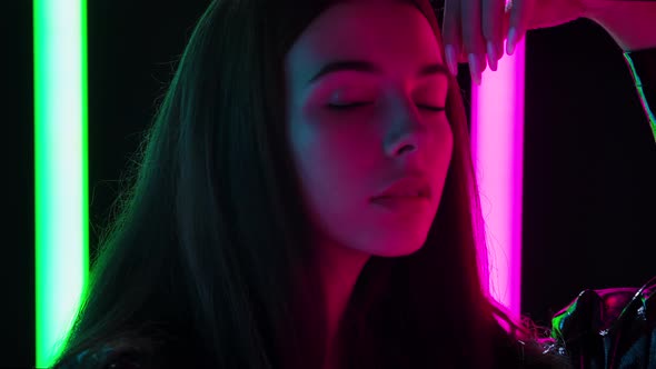 Portrait of a Pretty Young Beautiful Woman Passionately Looking at the Camera and Posing with Hands alt