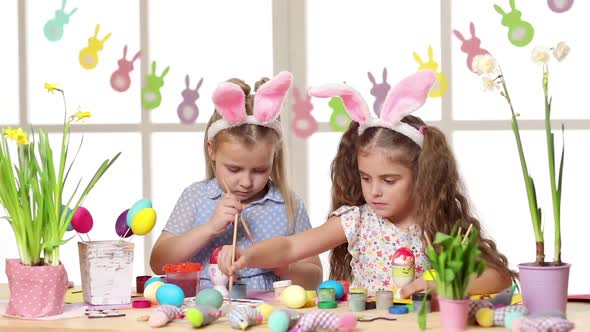 Happy Children Wearing Bunny Ears Painting Eggs on Easter Day