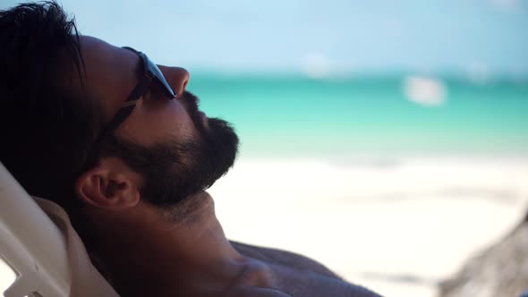 Businessman Resting Beach Hotel Luxury. Man Lies On Sunbed On Vacation. Guy Lying On Sun Lounger. alt