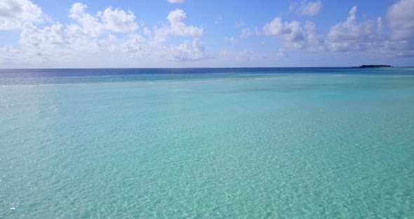 Daytime drone island view of a white sandy paradise beach and aqua blue water background in colorful alt