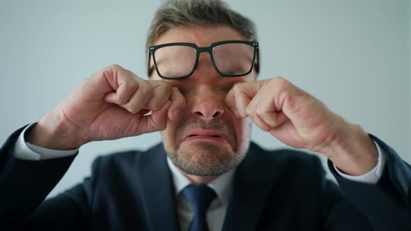 Humorous Portrait of a Confused Businessman First He Rubs His Eyes Under His Glasses and Then Looks alt