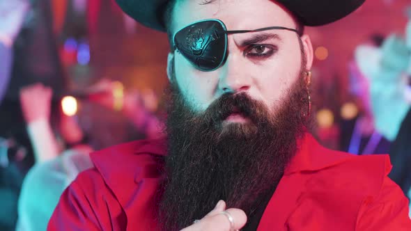 Portrait of a Young Man Dressed in Pirate Costume with an Evil Look and Big Black Beard alt