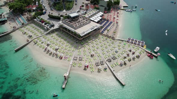 Aerial View Azure Beach with Empty Sun Loungers Balkan Coast Ionian Sea Albania alt