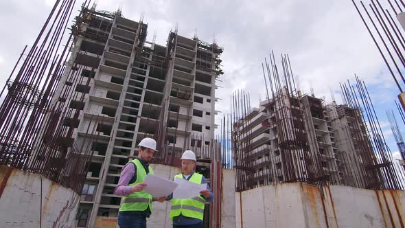 Engineer and Young man Architect on a building Construction Site