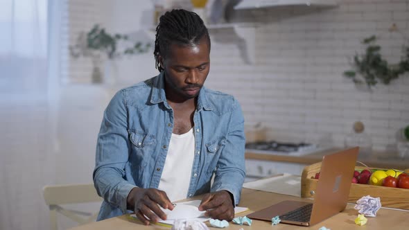 Middle Shot of Angry Stressed African American Man Tearing and Crumpling Paper Working Online at alt