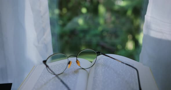 Eyeglasses on an open book